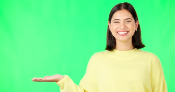 Happy woman, hand and green screen for product placement, advertising or marketing against studio background. Portrait of female face with smile showing advertisement or sale on copy space mockup. - Záběry, video