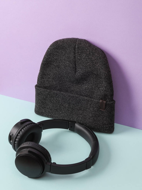 Creative layout with hat and headphones, pastel background. Minimal still life - Photo, Image