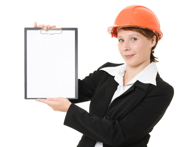Businesswoman in a helmet shows the blank page on a white background. - Zdjęcie, obraz