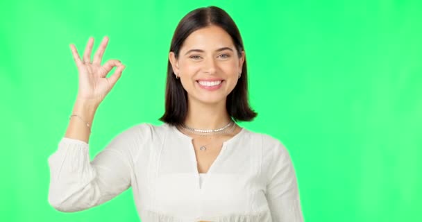 Ok hands, face and happy woman on green screen, background and studio in agreement of support. Portrait of female model, smile and okay for success, yes and winner of perfect emoji, thank you or hope. - Πλάνα, βίντεο