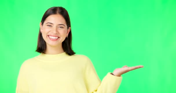 Happy woman, face and hand on green screen for product placement, advertising or marketing against studio background. Portrait of female with smile showing advertisement or sale on copy space mockup. - Footage, Video