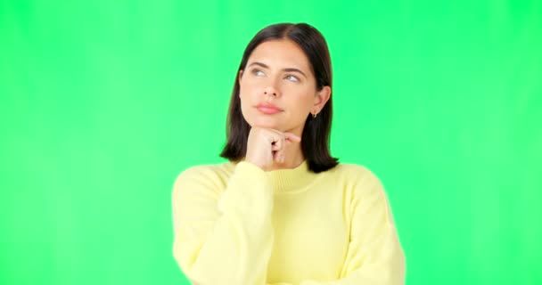 Face, thinking and consider with a woman on a green screen background in studio to decide her options. Idea, mind and contemplating with an attractive young female looking thoughtful on chromakey. - 映像、動画