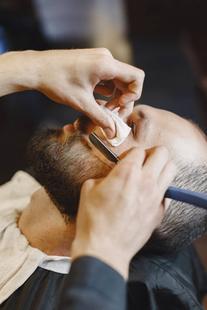 Man with a beard. Hairdresser with a client. Man with a shave. - Foto, Imagem