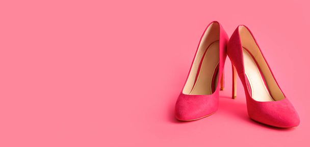 Pair of stylish high heeled shoes on pink background with space for text - Photo, Image