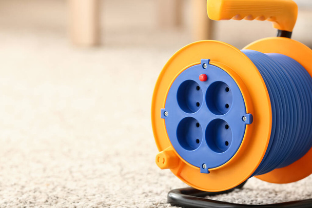 Extension electric cable reel on carpet, closeup - Photo, Image