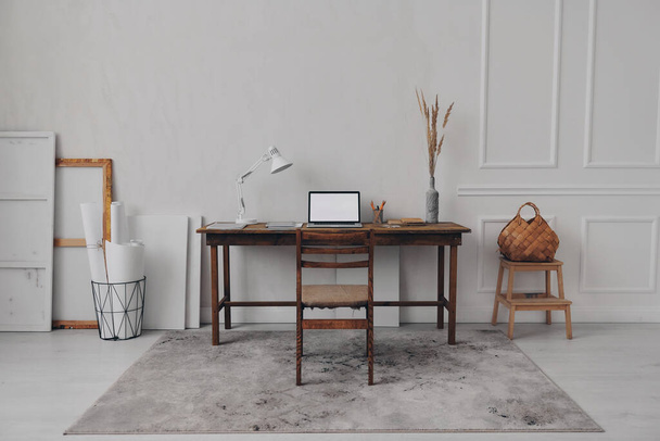 No people shot of creative workplace with laptop laying on the wooden desk - Фото, изображение