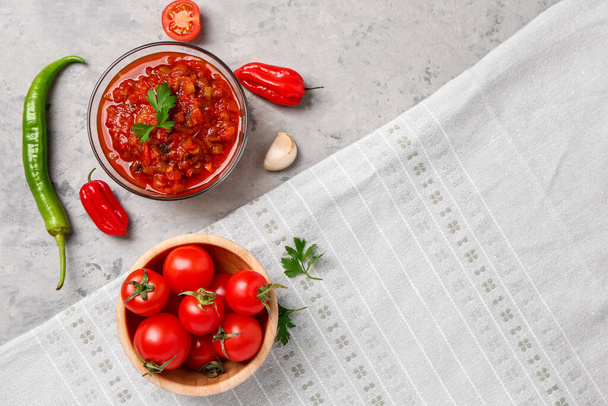 Composition with bowl of delicious salsa sauce and ingredients on grey grunge background - Photo, Image