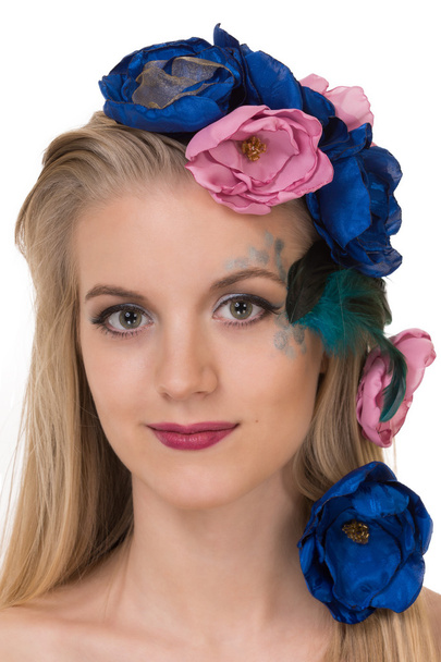 Beautiful young blond woman with the flowers on head and feather - Photo, Image