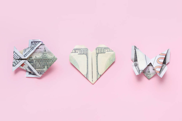 Origami made of dollar banknotes on pink background - Фото, зображення