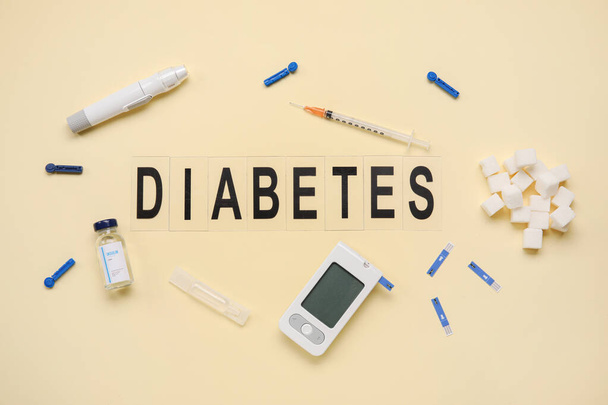 Word DIABETES with medical supplies on beige background - Foto, imagen