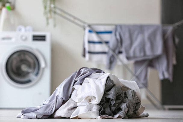 Montón de ropa sucia en el suelo en la lavandería, primer plano - Foto, Imagen
