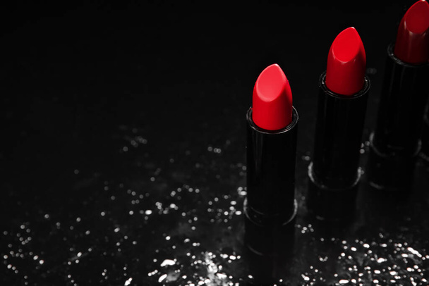 Set of beautiful lipsticks on dark background - Photo, image