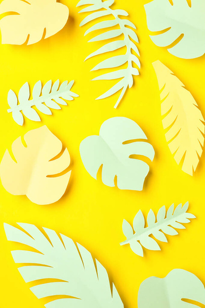 Paper tropical leaves on yellow background - Фото, зображення