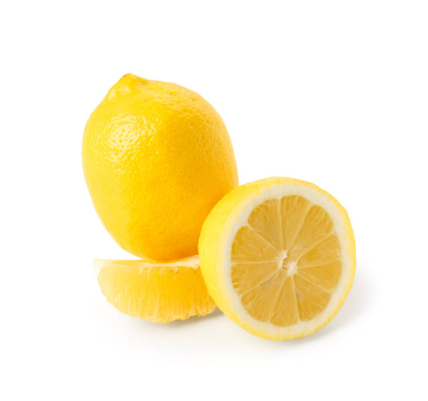Whole and cut fresh lemons on white background - Foto, afbeelding