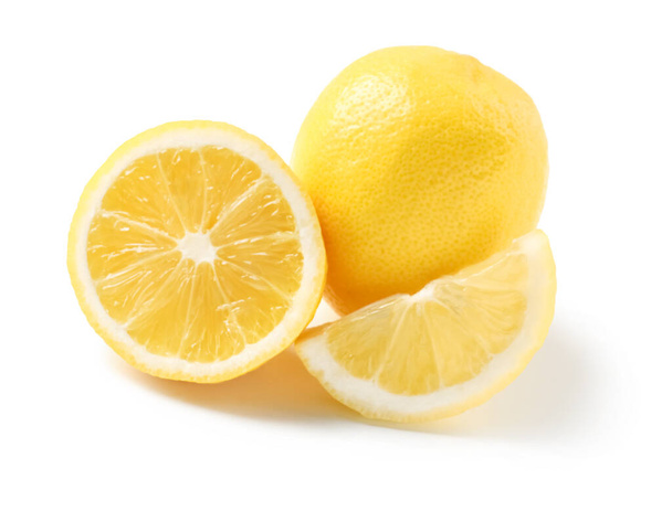 Whole and cut fresh lemons on white background - Foto, Imagen
