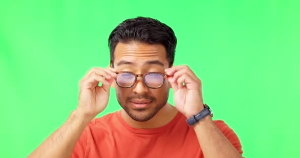 Gezicht, bril en visie met een man op een groene achtergrond in de studio die lacht om zijn gezichtsvermogen. Portret, brillen en receptbril lenzen met een knappe jonge man op chromakey. - Video
