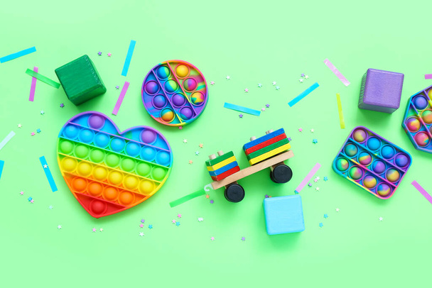 Toys with confetti on green background. Children's Day celebration - Фото, зображення