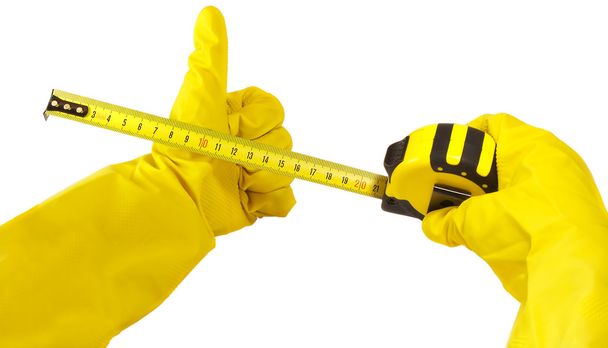 Gloved hand holding measuring tape isolated on white - Foto, Imagen