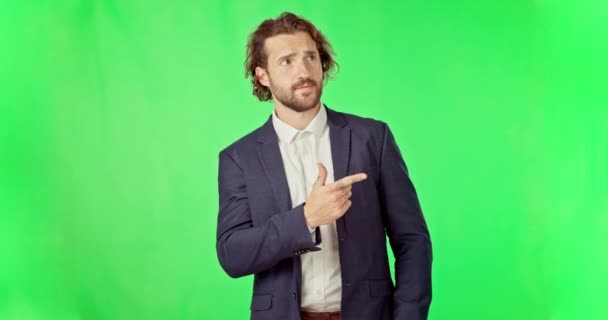 Business man, pointing and confused face by green screen for decision, options and ideas by background. Businessman, choice and point hands with thinking in studio mock up with chroma key backdrop. - Materiaali, video