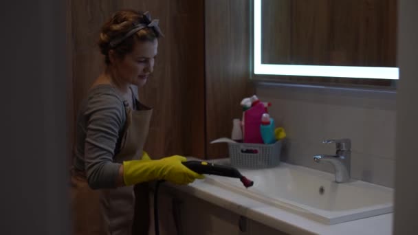 wet cleaning the bathroom with a steam cleaner. - Footage, Video