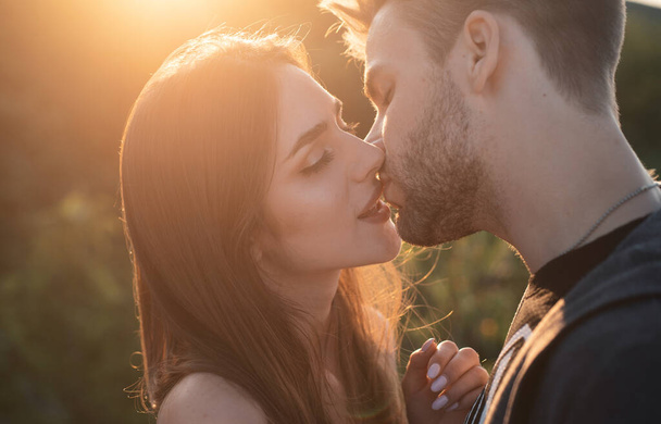 Sensual kissing on sunset. Couple In Love. Intimate relationship and sexual relations. Closeup mouths kissing. Passion and sensual touch. Romantic and love - Photo, Image