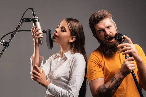 Karaoke singers couple. Woman and man singing with music microphone - Фото, зображення