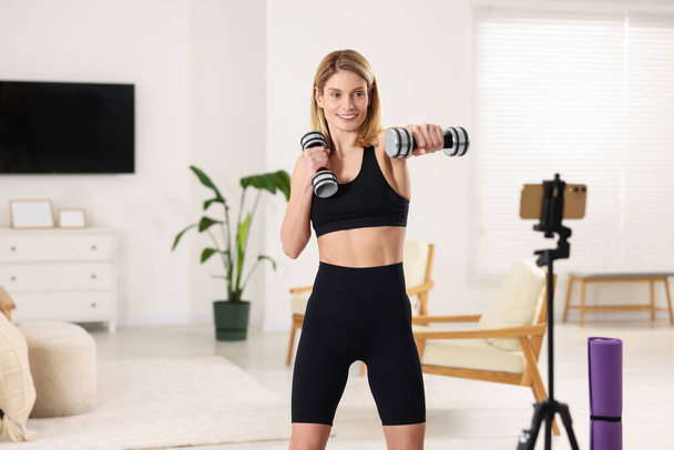 Fitness trainer recording online classes at home - Zdjęcie, obraz