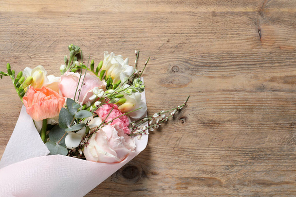 Bouquet of beautiful flowers on wooden table, top view. Space for text - Foto, Imagem