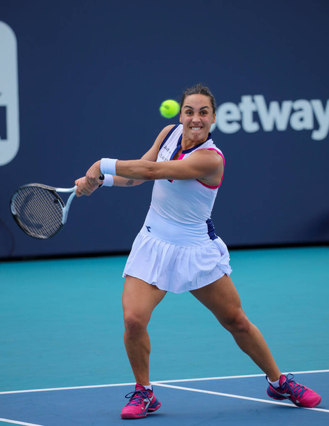 MIAMI GARDENS, FLORIDA - MARCH 27, 2023: Martina Trevisan of Italy in action during round 3 match against Jelena Ostapenko of Latvia at 2023 Miami Open at the Hard Rock Stadium in Miami Gardens, Florida, USA - Фото, изображение