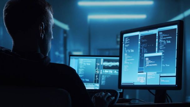 Computer Hacker in Hoodie. Obscured Dark Face. Hacker Attack, Virus Infected Software, Dark Web and Cyber Security concept. - Foto, imagen