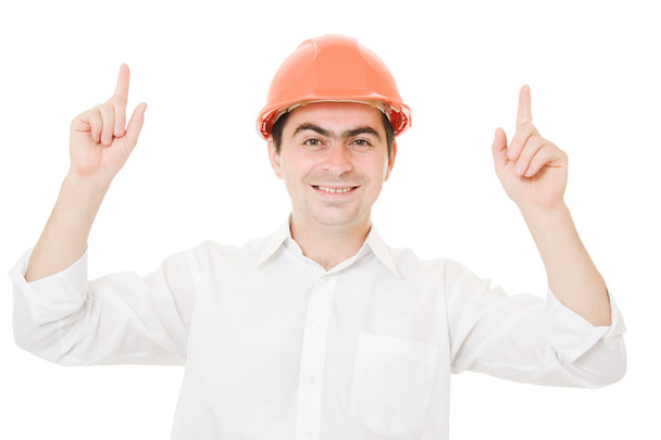 Businessman in helmet pointing up. - Фото, изображение