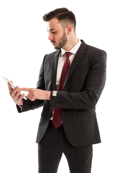 Business man checking sales on a tablet - Foto, Bild