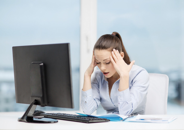 stressed woman with computer and documents - 写真・画像