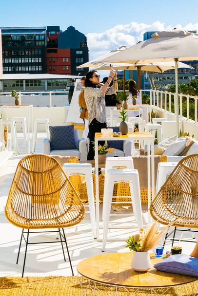 Cape Town, South Africa - November 15, 2022: Outdoor patio furniture on rooftop venue - Photo, Image