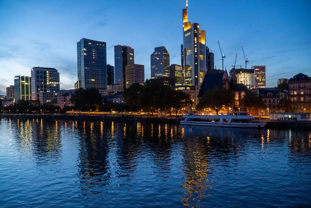 The skyline of Frankfurt am Main with skyscraper reflections on the river - 写真・画像