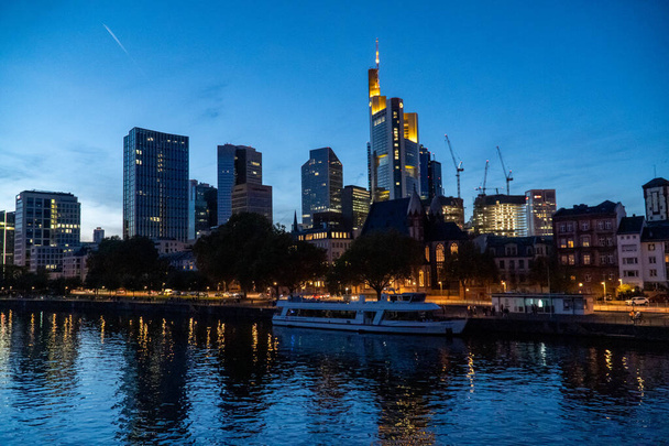 The skyline of Frankfurt am Main with skyscraper reflections on the river - 写真・画像