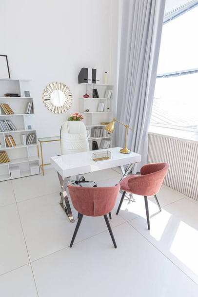 Cozy luxury modern interior design of a studio apartment in extra white colors with fashionable expensive furniture in a minimalist style. white tiled floor, kitchen, relaxation area and workplace - Fotografie, Obrázek