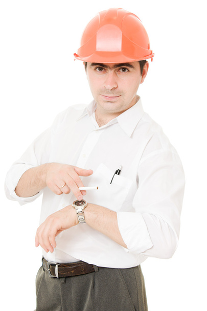 Businessman in a helmet with a cigarette. - Photo, Image