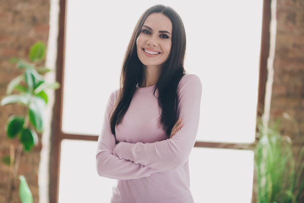 Photo of pretty confident young lady dressed pink shirt arms crossed smiling indoors house room. - Photo, image