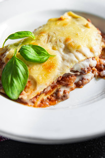 lasagna classic dish bechamel sauce, minced meat, grated cheese healthy meal food snack on the table copy space food background rustic top view - Foto, imagen