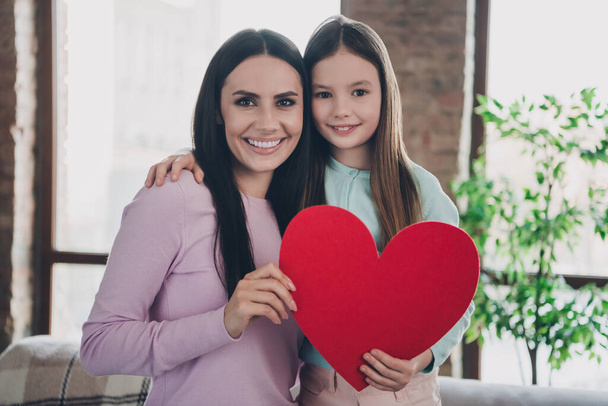 Photo of lovely adorable family mom daughter celebrate mother day with heart shape greeting card surprise in apartment. - Fotó, kép