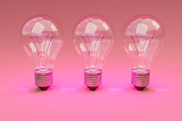 three retro style lightbulbs with glowing filament standing in a row on infinite colorful background; creativity design concept; 3D Illustration - Foto, Imagen