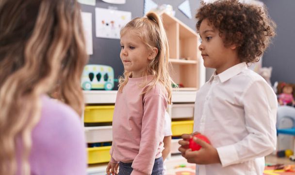 Woman with boy and girl having lesson at kindergarten - Photo, Image