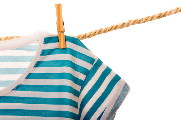 blue tshirt hanging on a rope clothesline - 写真・画像