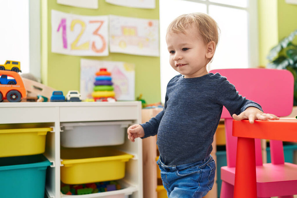 Adorable blond toddler smiling confident standing at kindergarten - Zdjęcie, obraz