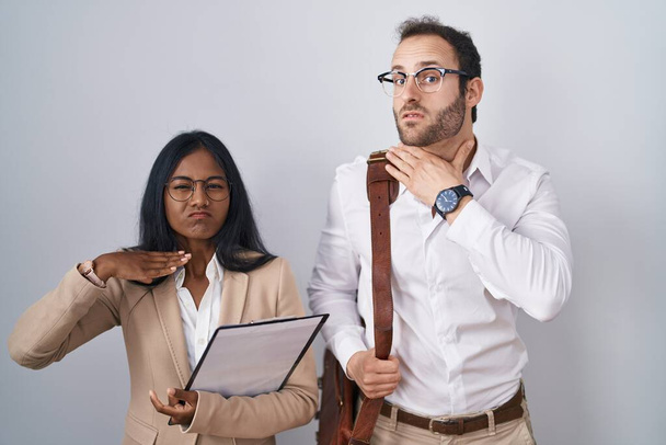 Interracial pareja de negocios con gafas de corte de garganta con la mano como cuchillo, amenazan la agresión con la violencia furiosa  - Foto, Imagen