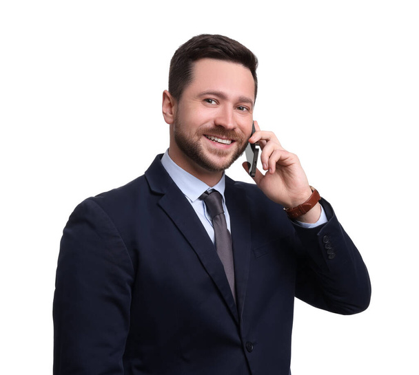 Handsome bearded businessman in suit talking on smartphone against white background - Фото, изображение