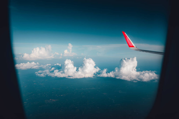 lentäminen ja matkustaminen, näkymä lentokoneen ikkunasta, pilvet ja taivas ilma-aluksen ikkunan läpi nähtynä  - Valokuva, kuva