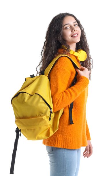 Female student with headphones and backpack on white background - Photo, image