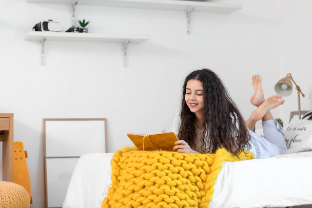 Teenage girl with notebook in bedroom - Photo, image